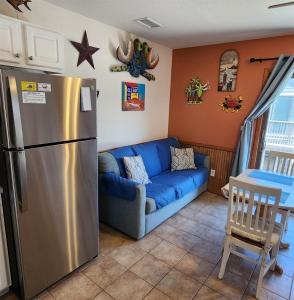 a living room with a refrigerator and a couch at NC 12 56821-9 Condo in Hatteras