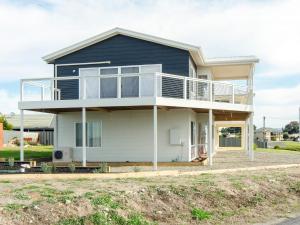 a blue and white house with a balcony at Riverside Dream - 109 Barrage Rd in Goolwa South
