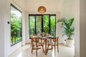 a dining room with a table and chairs at Bali Dream Garden - Tropical Escape with Pool & Spa in Ubud