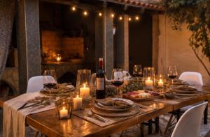 a long wooden table with candles and wine glasses at casa rural El Burrillo in Cuenca