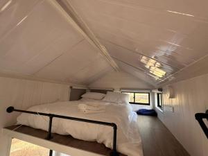 a bed in the middle of a small room at Tiny House Adventure by Tiny Away in Tallarook