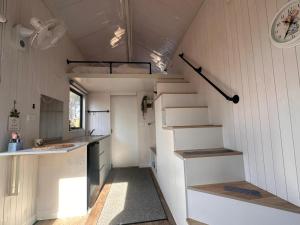 a small kitchen with stairs in a tiny house at Tiny House Adventure by Tiny Away in Tallarook