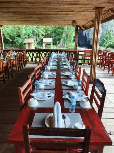 a long table with chairs and plates on it at Namnoncave Resort in Ban Namnon +58 photos
