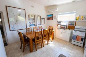 a kitchen and dining room with a table and chairs at Hawker Bed and Breakfast in Hawker