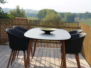 a table and chairs on a patio with a view at Valomerius Charming holiday home in Maarkedal