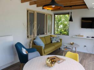 a living room with a couch and a table at Valomerius Charming holiday home in Maarkedal