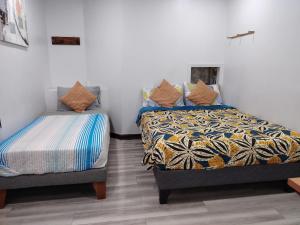 a bedroom with two beds and a bedskirts at hostal mancora in Santiago
