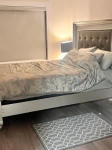 a bedroom with a large bed with a silver frame at Peace House in Bills Island