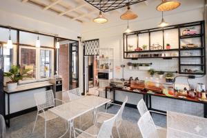 a dining room with a table and chairs at Sherloft Home & Hostel in Chiang Mai