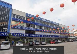a building with red lanterns hanging over a parking lot at Hotel 99 Bandar Klang (Meru) in Klang