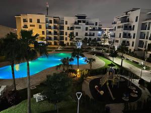 an overhead view of a swimming pool at night at Luxury Apartment in martil in Martil