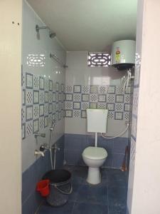 a bathroom with a toilet and a bucket in it at Sri Durga Nilayam in Bhadrāchalam
