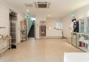 a room with a store with a staircase in it at Hotel YAM Yeosu Hakdong in Yeosu