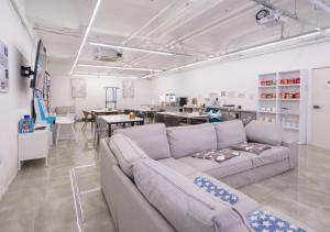 a living room with a couch and a dining room at Hotel YAM Yeosu Hakdong in Yeosu
