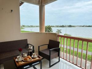 a table and chairs on a balcony with a view of the water at Location meublee Kourou pour 5 personnes plus 1 bebe in Kourou