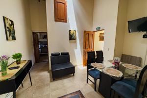 a living room with a table and chairs at Apartahotel Balcones de Nariño in Villa de Leyva