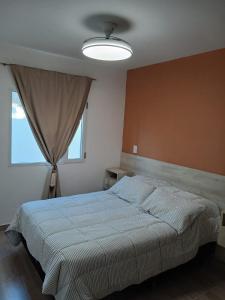 a bedroom with a bed and a large window at Listo para vos in RSA
