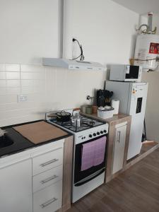 a kitchen with a stove and a refrigerator at Listo para vos in RSA