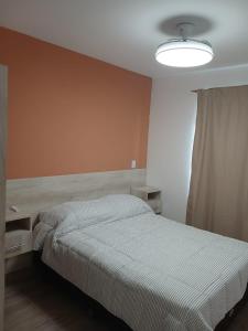 a bedroom with a bed and a lamp in it at Listo para vos in RSA +4 photos