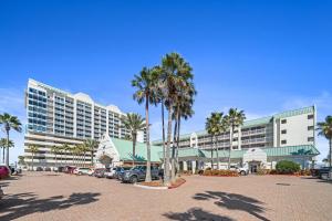 a large hotel with cars parked in a parking lot at Oceanfront 1BR Condo Daytona Resort Pool Access in Daytona Beach