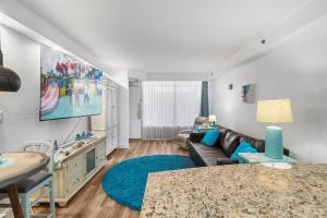 a living room with a couch and a table at Oceanfront 1BR Condo Daytona Resort Pool Access in Daytona Beach