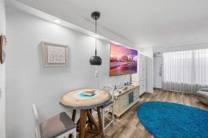 a living room with a table and a sink at Oceanfront 1BR Condo Daytona Resort Pool Access in Daytona Beach +11 photos