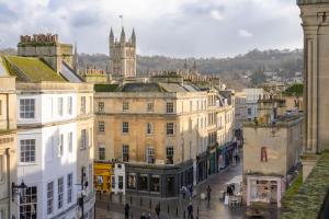 a city street with buildings and a clock tower at Milsom Loft in Bath