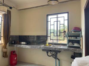 a kitchen counter with a sink and a window at Authentic Joe homestay in Siem Reap +15 photos