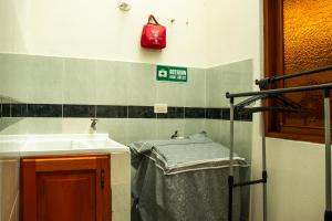 a small bathroom with a sink and a sink at Apartahotel Balcones de Nariño in Villa de Leyva +13 photos