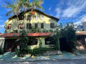 a house with a palm tree in front of it at Casa Sankofa de Belém in Belém