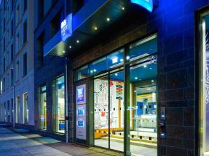 a store front of a building at night at Ibis Budget Leipzig City in Leipzig +7 photos