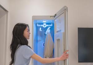 a young woman pointing at a blue refrigerator at Hotel YAM Yeosu Hakdong in Yeosu +109 photos