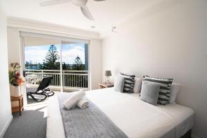 a bedroom with a large bed and a large window at Ocean Sands Resort in Gold Coast +70 photos