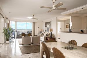 a living room with a dining table and a living room at Ocean Sands Resort in Gold Coast