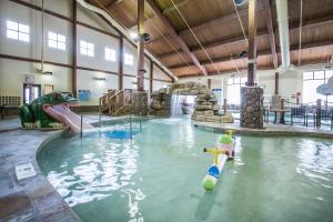 a large indoor swimming pool with a water slide at Hilton Grand Vacations Christmas Mountain Village Wisconsin in Wisconsin Dells
