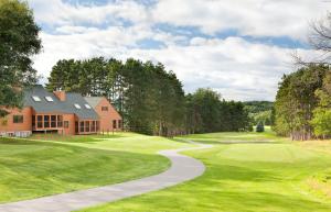 a house on a golf course with a path leading to the green at Hilton Grand Vacations Christmas Mountain Village Wisconsin in Wisconsin Dells