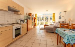 a kitchen and living room with a couch and a table at Wattschnecke in Böhl