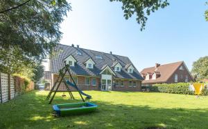 a playground in a yard in front of a house at Wattschnecke in Böhl