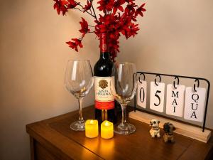 a table with a bottle of wine and two glasses at Loft no Hotel Quitandinha Experiência Única in Petrópolis