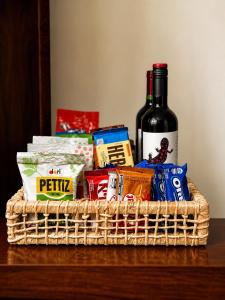a basket with a bottle of wine and some snacks at Loft no Hotel Quitandinha Experiência Única in Petrópolis +10 photos