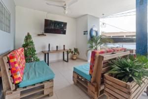 a living room with two chairs and a christmas tree at Oleajes Capurganá in Capurganá