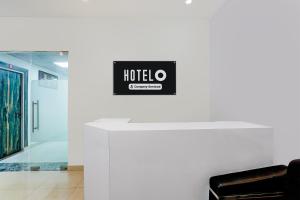 a hotel sign on a wall in a room at Super Hotel O Greater Noida West Link Road Formerly Advent in Noida