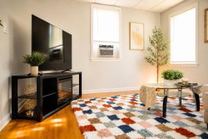 a living room with a television and a rug at Private Room #3 Fall River MA in Fall River