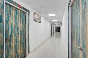an empty hallway in an office building with a large door at Super Hotel O Greater Noida West Link Road Formerly Advent in Noida +31 photos