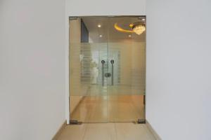a room with a shower with a glass door at Super Hotel O Greater Noida West Link Road Formerly Advent in Noida