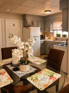 a kitchen with a dining table and a white refrigerator at Private Room #3 Fall River MA in Fall River
