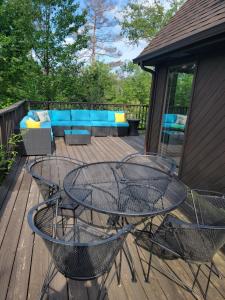 a patio with a table and chairs on a deck at Secluded Chalet in Harrison