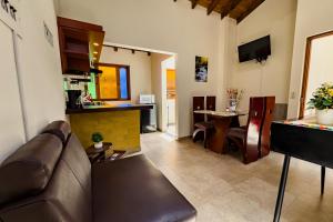 a living room with a couch and a table at Apartahotel Balcones de Nariño 2 in Villa de Leyva