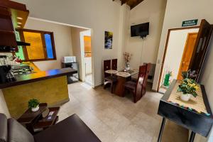 a living room with a kitchen and a dining room at Apartahotel Balcones de Nariño 2 in Villa de Leyva