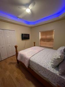 a bedroom with a bed and a ceiling fan at Pool Home in Englewood +18 photos